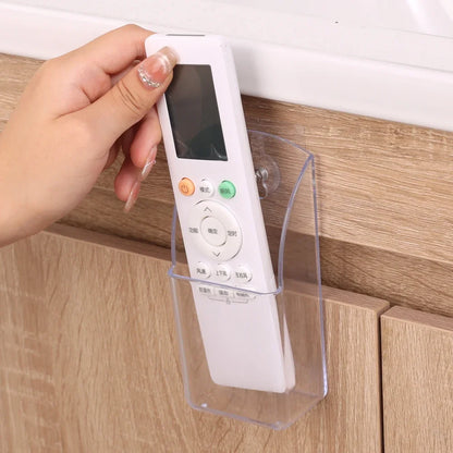 Wall mounted transparent remote holder.