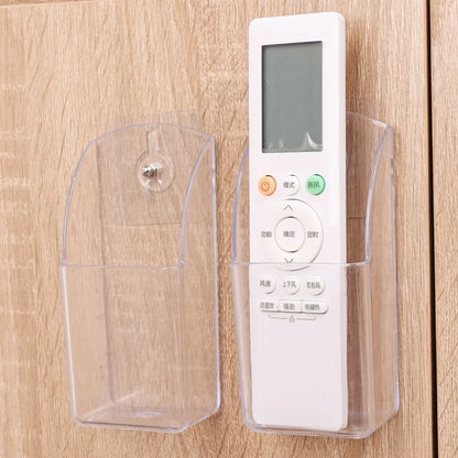 Wall mounted transparent remote holder.