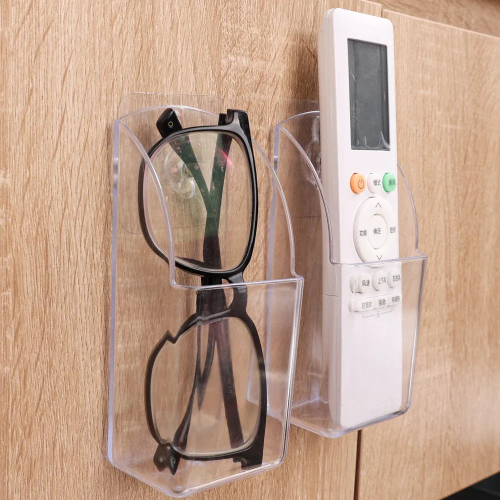 Wall mounted transparent remote holder.